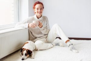 Side view Young Woman wears sweater Drinks Tea
