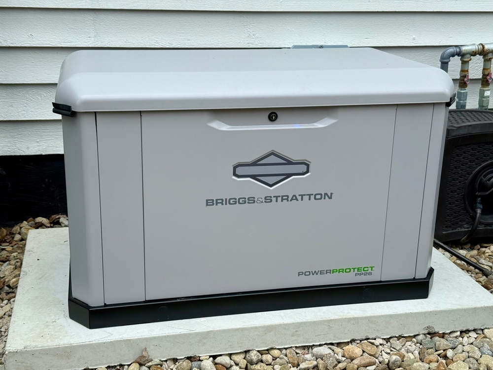 Briggs & Stratton PowerProtect PP26 standby generator installed on a concrete slab