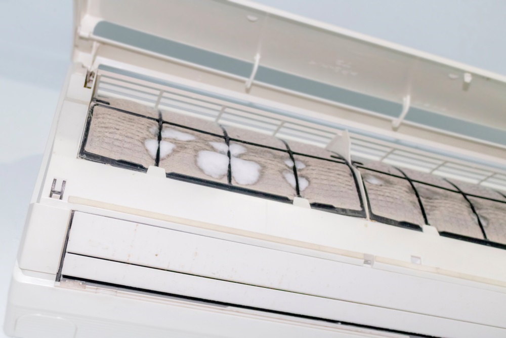 Photo of Iced and dusted air conditioner's filter before cleaning by mechanic