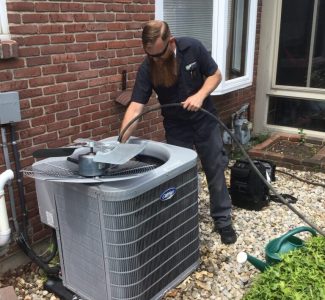 Jon Kinghorn working on an AC replacement