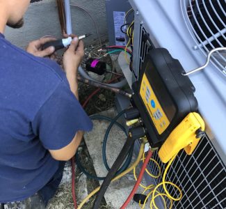 Timothy Israel working on an AC replacement